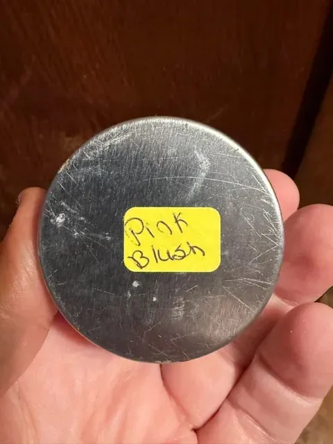 A silver tin with a handwritten Pink Blush label.