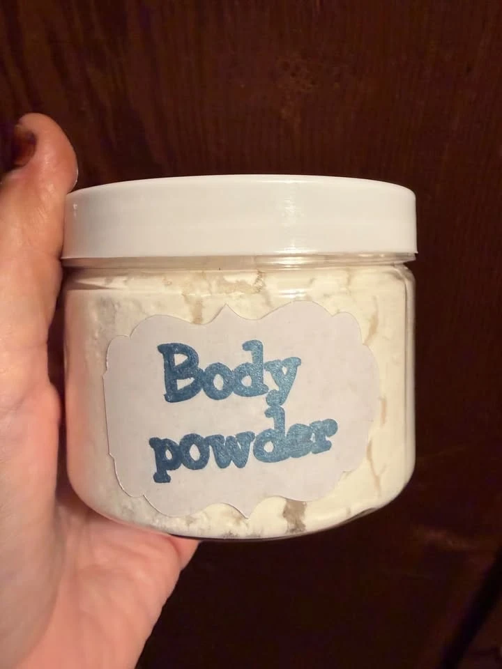 A white jar with a handwritten Body powder label.